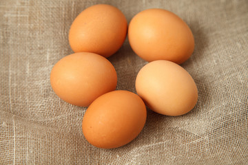 eggs on the tableChicken eggs on burlap vintage background