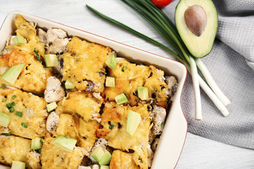 Roasted chicken with cheese in casserole dish, closeup