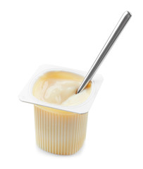 Plastic cup with yogurt and spoon on white background