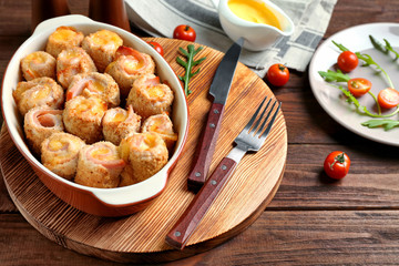 Crockpot with delicious chicken cordon bleu on wooden board