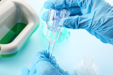 Fototapeta premium Doctor preparing compressor nebulizer for use, closeup