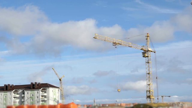 Construction cranes working on high-rise building