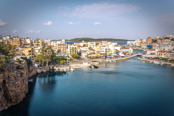 Fototapeta na wymiar The lake Voulismeni in Agios Nikolaos, a picturesque coastal town with colorful buildings around the port in the eastern part of the island Crete, Greece
