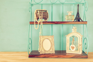 Classic shelf with vintage objects and blank frame