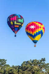 Fototapeta na wymiar Two Hot Air Balloons Rising in the Morning Air