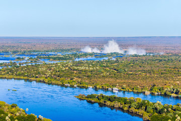 Zambezi river and Victoria falls, the largest curtain of water in the world, view from helicopter.