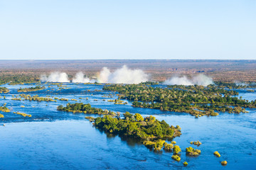 Zambezi river and Victoria falls, the largest curtain of water in the world, view from helicopter. - obrazy, fototapety, plakaty