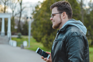 young man in the park with phone