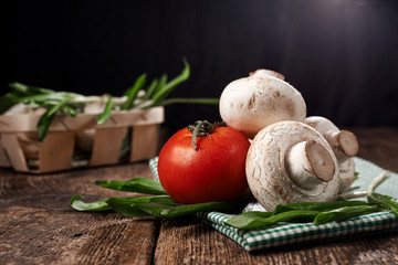 Mushrooms, tomato, greens on a napkin