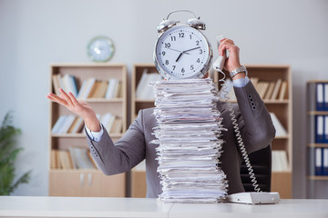 Businessman busy with paperwork in office