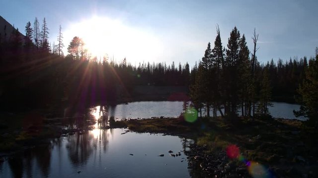 Flying towards the sun over pond