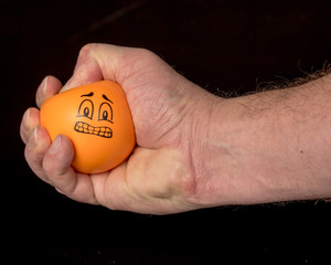 Human hand squeezes a stress ball