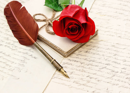 Red rose flower old letters antique feather pen