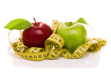 Red and green apple with measuring tape