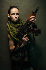 Fototapeta na wymiar Young woman soldiers with guns