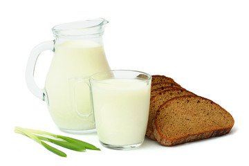 Glass jug pitcher of fresh milk with glass and black bread isolated on white background carafe