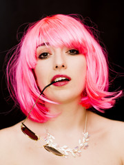 Fototapeta premium Beauty Woman With Pink Wig And Sunglasses Over Black Background