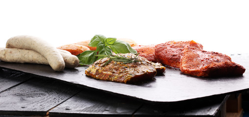 Selection of marinaded meat for grilling and sausages