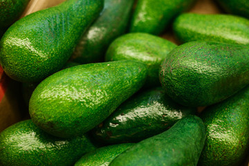 Green fresh delicious avocado. Healthy nutritious food. Background.