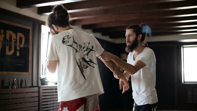 Twin brothers practice in Chinese martial arts in the training hall
