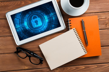 Web security and technology concept with tablet pc on wooden table