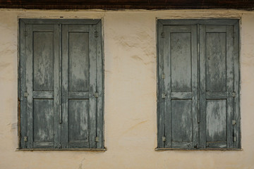 Old, wooden, closed casement windows of old house