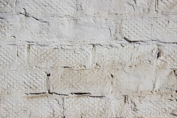 Texture of a brick wall coated with white paint