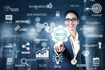 Young businesswoman presses SEO icon
