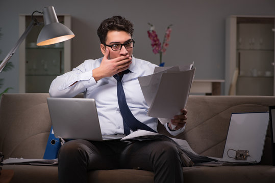 Businessman workaholic working late at home