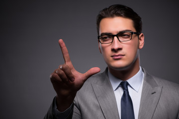 Handsome businessman pressing virtual buttons