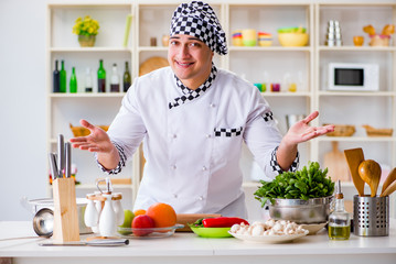 Young male cook working in the kitchen