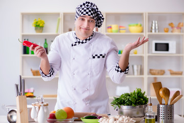 Young male cook working in the kitchen