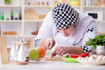 Young male cook working in the kitchen