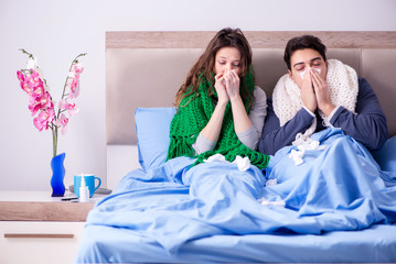 Obraz na płótnie Canvas Sick wife and husband in bed in home