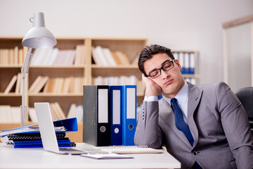 Sleepy businessman working in office