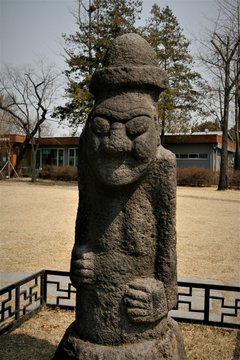 a stone grandfather statue, called Dol hareubang in jeju korea
