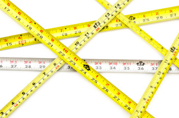 Tape measures on a white surface