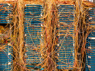 Close up of messy phone line box, details of cables and plugs
