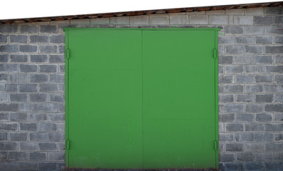 The texture of a painted metal gate from a brick garage