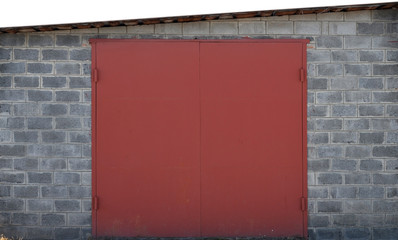 The texture of a painted metal gate from a brick garage