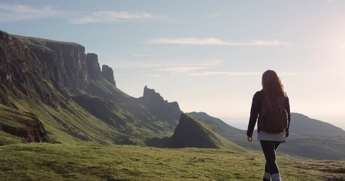 Woman with arms raised on top of mountain looking at view Hiker Girl lifting arm up celebrating scenic landscape enjoying nature vacation travel adventure  Quiraing Walk on the Isle of Skye in Scotland