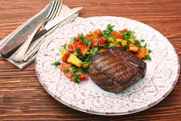 Grilled beefsteaks and vegetables