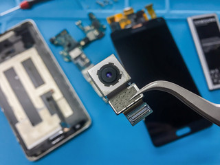 Close-up image of rear camera module on blurred smartphone component background