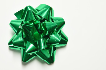 Green gift bow on white background
