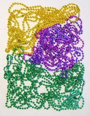 Green gold and purple Mardi Gras beads with trumpets