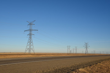 Electric power poles along a  prairie highway in Saskatchewan