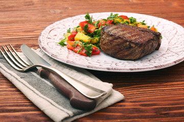 Grilled beefsteaks and vegetables