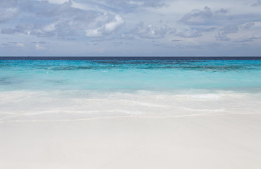 White beach sand and beautiful blue sea and sky
