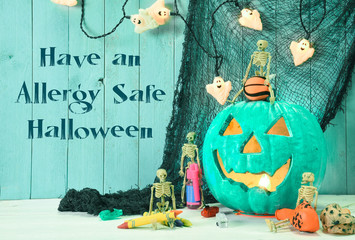 Teal Jack O Lantern  symbolizing alternative non food treats for Halloween with message