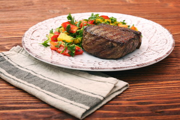 Grilled beefsteaks and vegetables